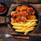 Currywurst Sausages with Curry spice on wursts served French fri